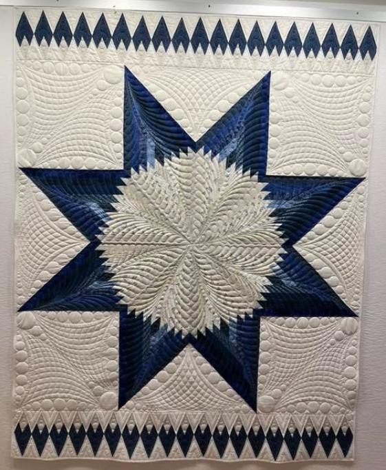 Navy and white lone star with elaborate feathered quilting and pebble fills